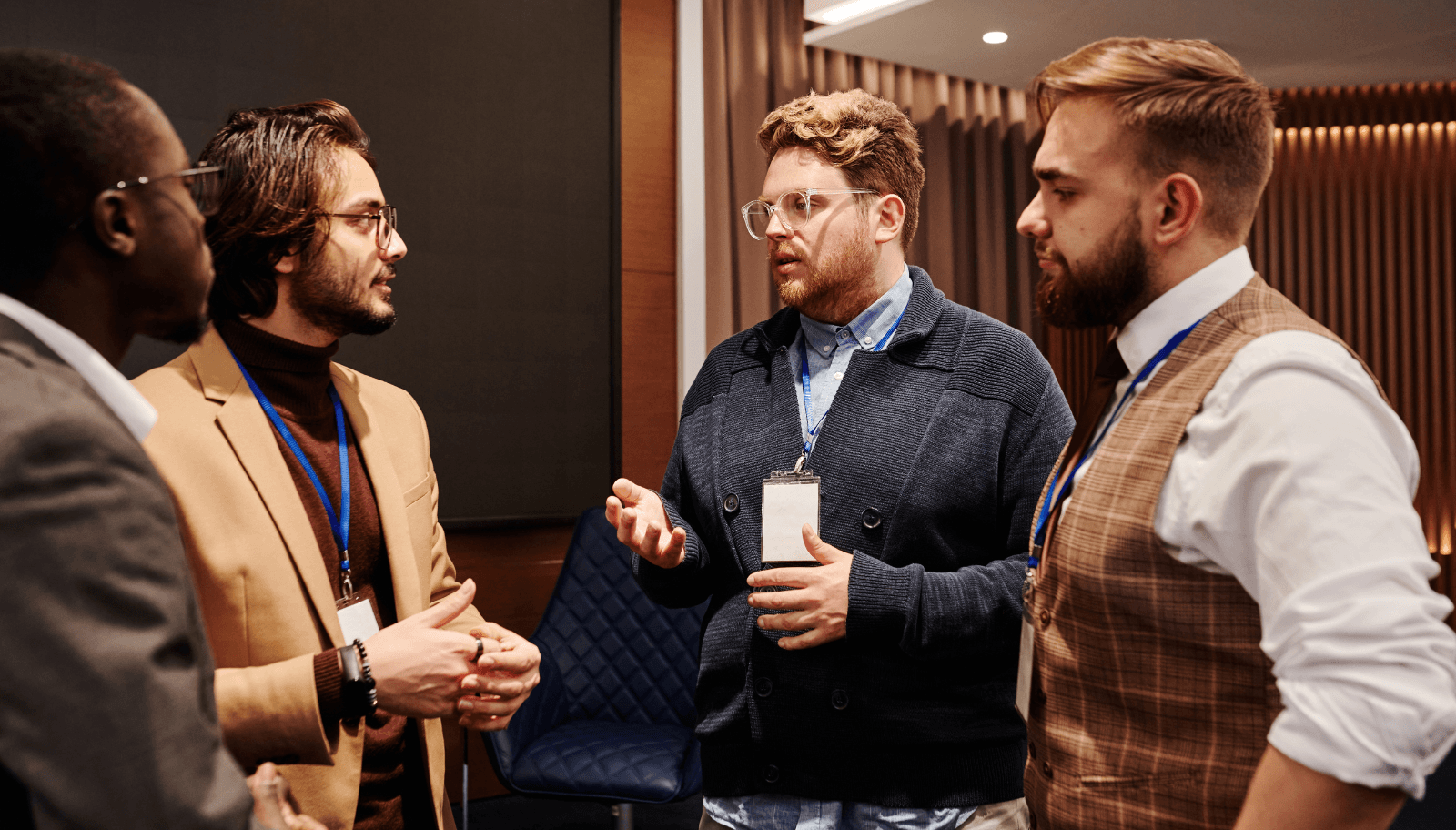 Event organizer answering attendee questions at a small meetup table